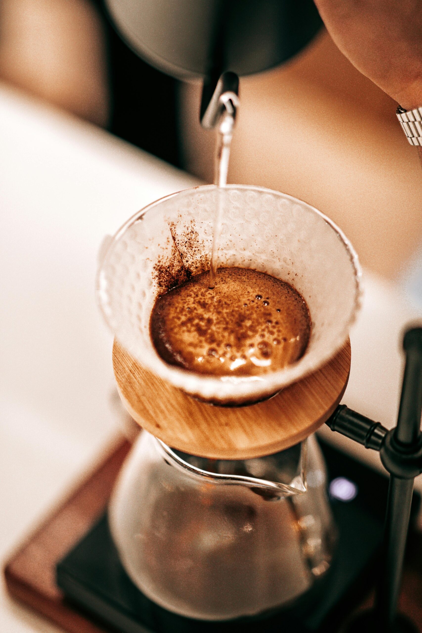 Close-up of a pour-over coffee process, showcasing the rich brewing method with focus on details.